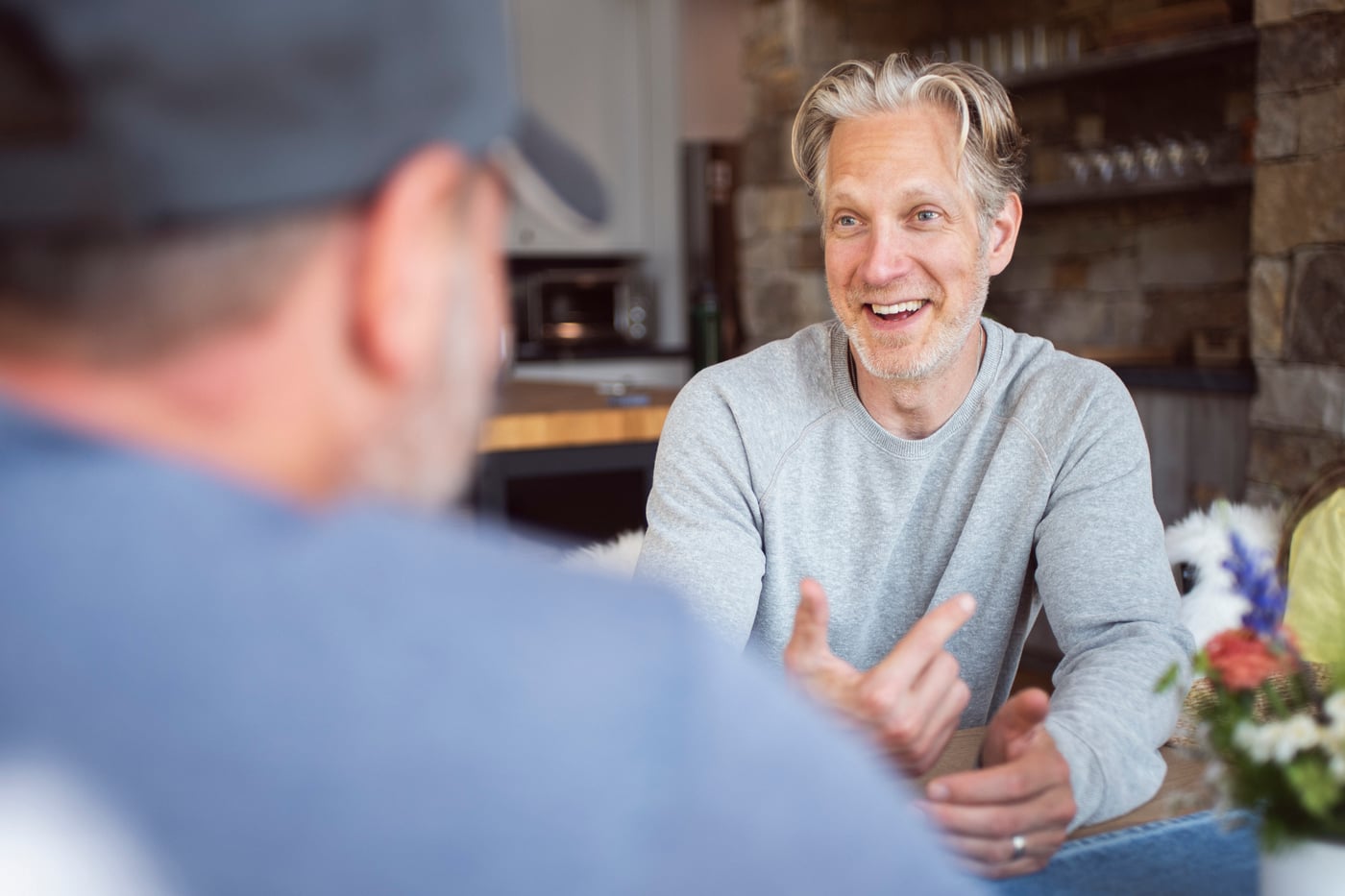 Randy smiling in conversation with another person across the table