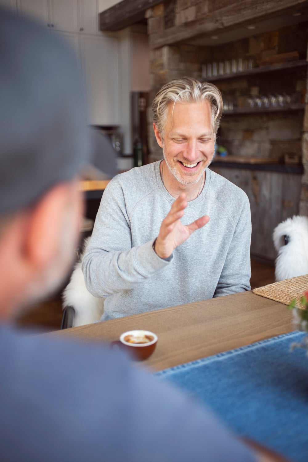 Randy in conversation with another person across a table