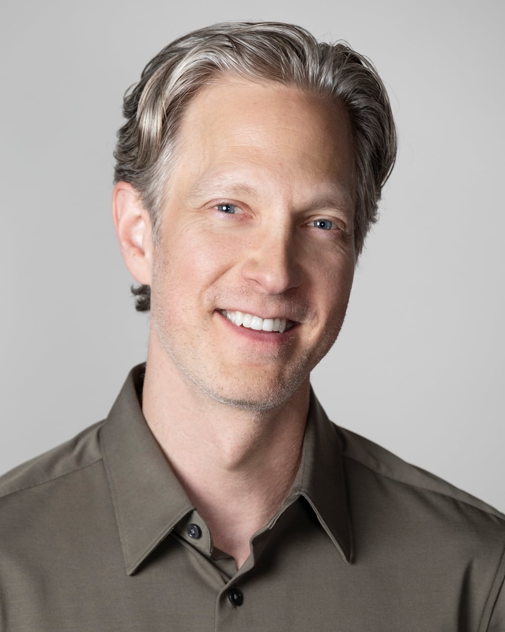 Randy smiling in an olive shirt